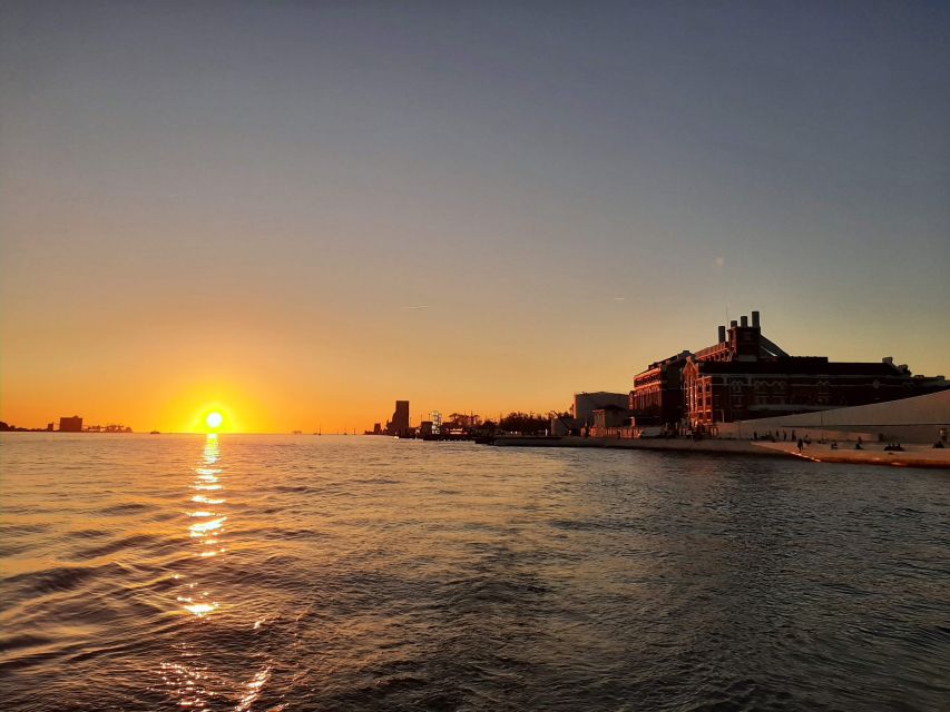 Lisbon: City Skyline Sailboat Cruise with Drink and Snacks - The 25th April Bridge pass: scenery with structure