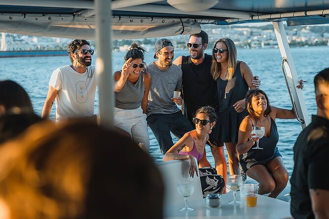 Lisbon: Sunset Catamaran Boat Tour with Music and Drinks - The sightseeing loop: Cristo Rei, the 25 de Abril Bridge, and Belém Tower from the water