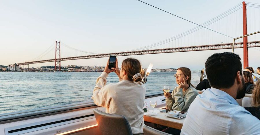 Lisbon: Sunset Cruise with Welcome Drink and Snacks - Onboard comfort: lounge music, WiFi, panoramic windows, and the welcome drink
