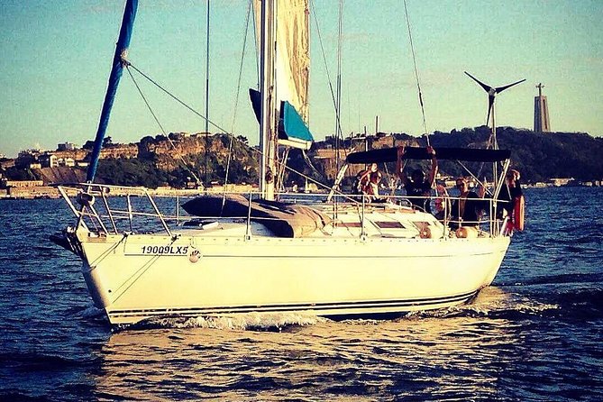 Lisbon Sunset Sailing Tour with White or Rosé Wine and Snacks - Ponte 25 de Abril and Cristo Rei from a moving perspective